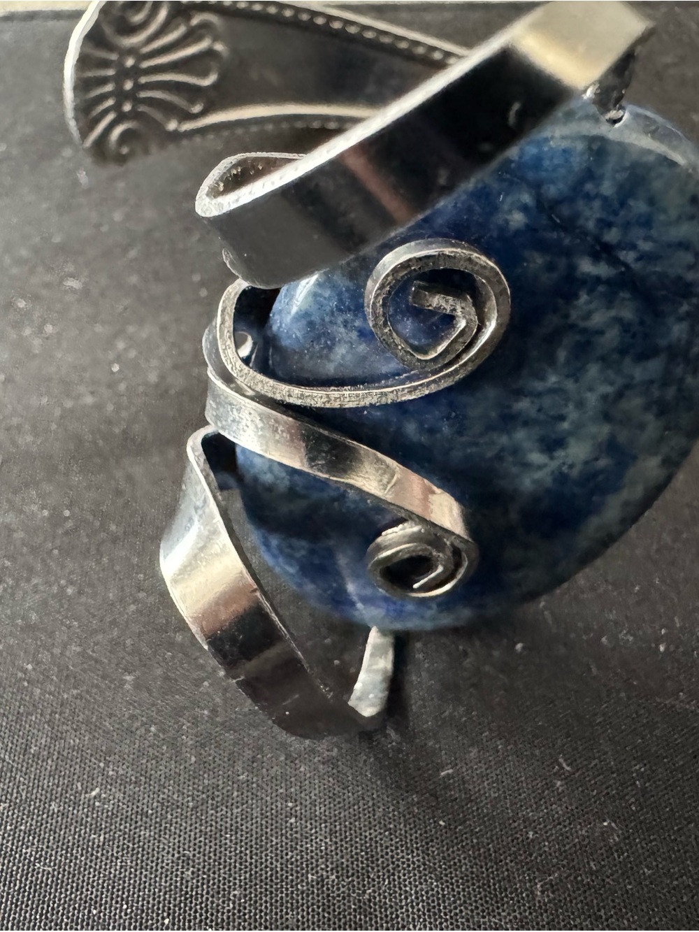 Bent silver fork with blue stone bracelet